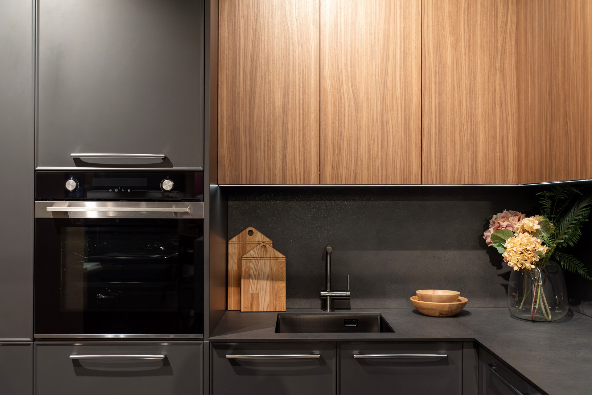 Modern gray kitchen with electric oven and kitchen faucet